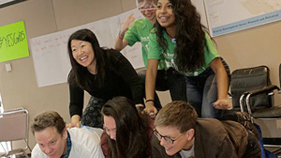 Students and facilitators attempt a human pyramid.