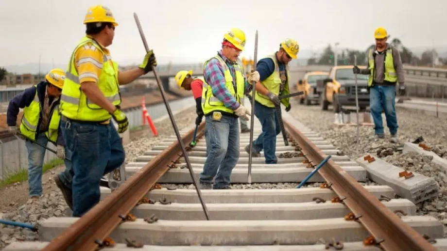 Construction crews do track work near the Washington Road overpass.
