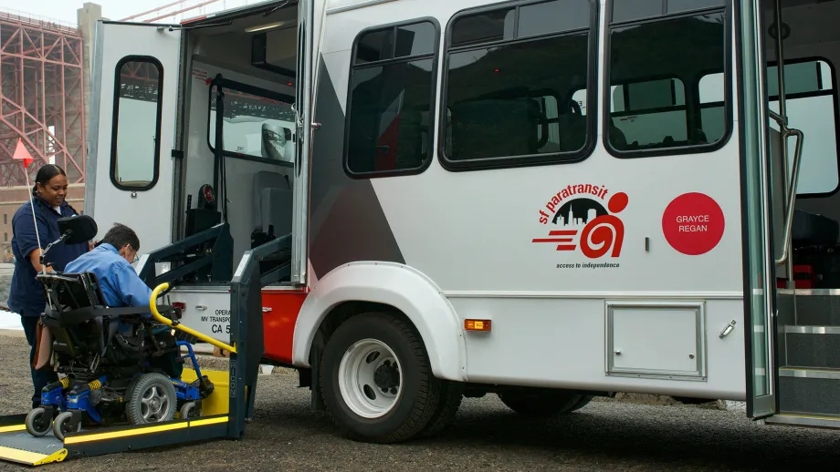 A person in a wheelchair boarding a SF Paratransit shuttle near Fort Point.