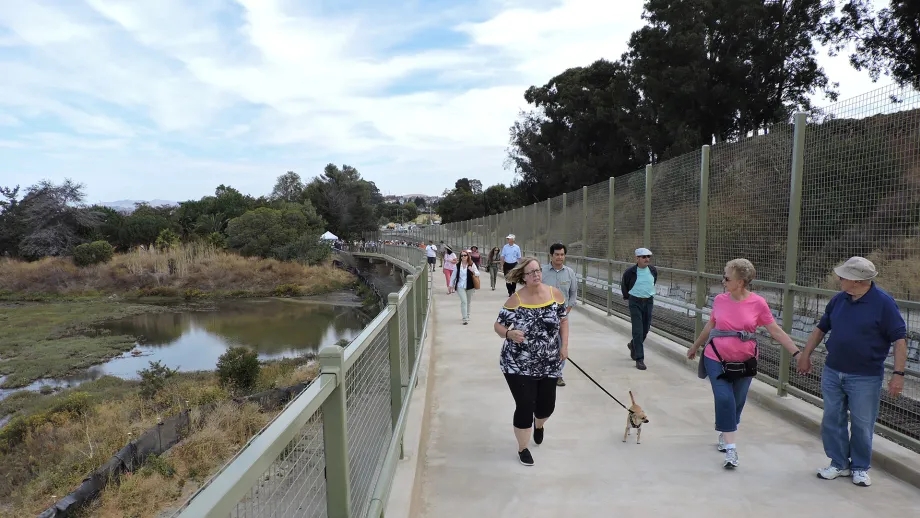 Pedestrians walking the boardwalk at Point Pinole Regional Shoreline.