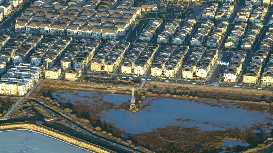 Aerial over seaside community at risk of sea level rise.