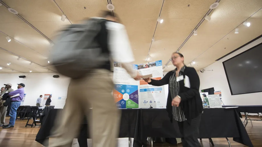 Two people shaking hands at an expo