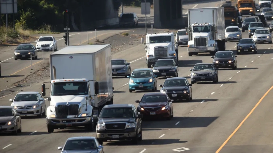 Trucks and cars in heavy traffic.