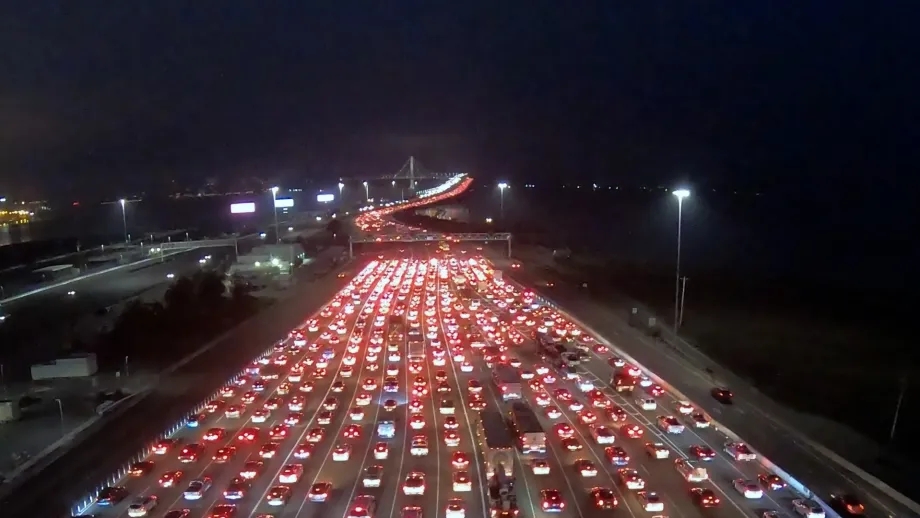 Aerial of heavy nighttime traffic on the San Francisco-Oakland Bay Bridge.