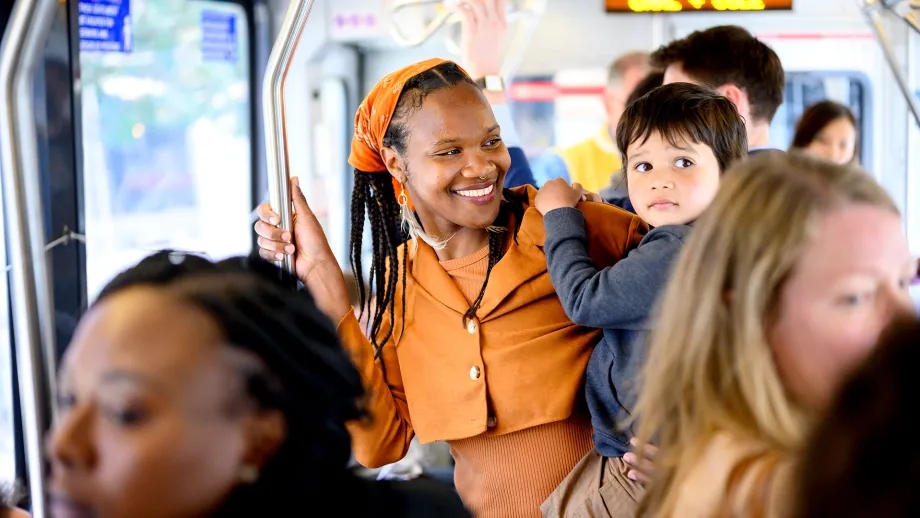 A smiling family on a Muni train.