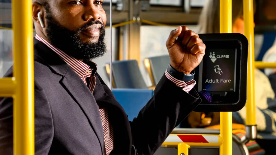 A businessman pays for transit with Clipper on his smart watch.