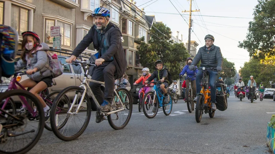 A "bike bus" of young students and their families commute to school by bicycle.